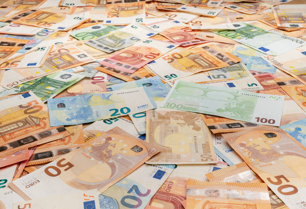 Banknotes of 5 to 100 euros scattered on the table - Photo, Image