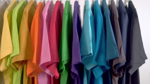  Close up of Colorful t-shirts on hangers, apparel background, Slider shot - Footage, Video