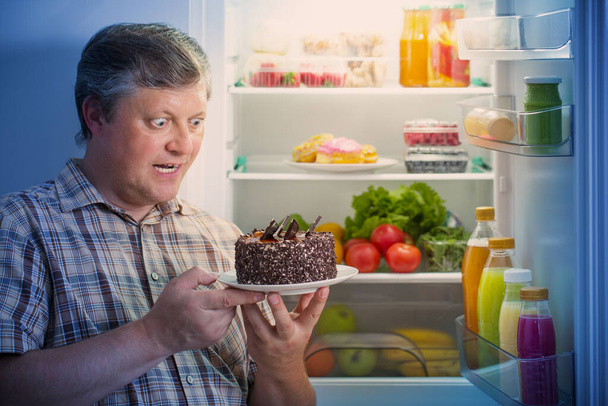 mature men at fridge  with food - Photo, Image