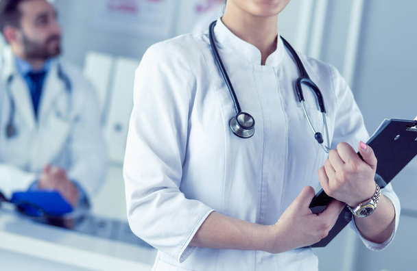 Woman doctor standing with stethoscope at hospital - Foto, Imagen