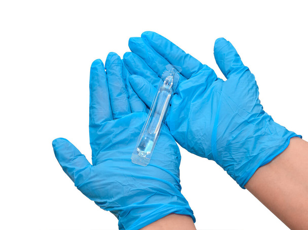 Bottle of injections in the arm, doctor's hands in medical gloves. Liquid medicine or vaccine for treating viral diseases in a laboratory or hospital. - Фото, изображение