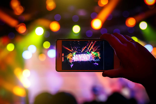 Fan taking photo of concert at festival by smatphone - Photo, Image