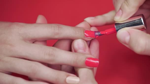 manicurist paints clients nails with beige tint nail polish - Footage, Video
