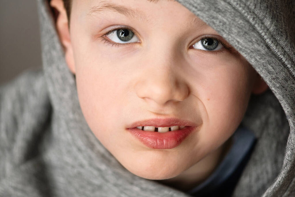 close-up, the boy looks and grimaces - Фото, изображение