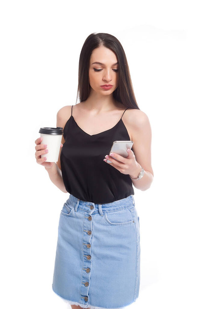 Young beautiful woman using smartphone,holding coffee cup and mobile phone.Lifestyle concept. Isolated on white background. - Fotoğraf, Görsel