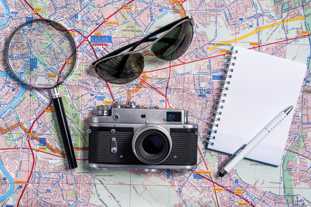 Концепция путешествия / Планирование основных элементов поездки летом путешествия аксессуары с фотоаппаратом солнцезащитные очки, камера, карта, ноутбук для путешественника, вид сверху
 - Фото, изображение