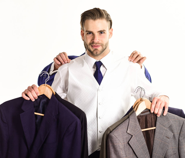 Man hold hangers with classic clothes. Businessman chooses outfit - Φωτογραφία, εικόνα