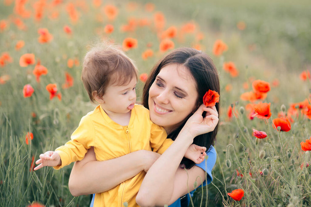 Happy Mom and Daughter in Beautiful Field of Poppies - Фото, изображение