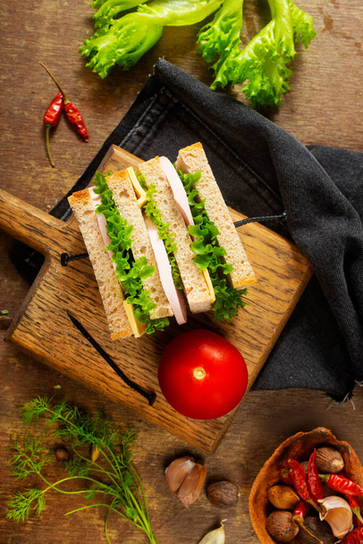 sandwiches on board, breakfast on a table, bread with boiled chicken - Zdjęcie, obraz