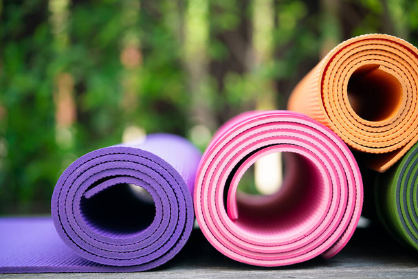 close up of colorful yoga mat on the table, sport and healthy concept - Фото, зображення