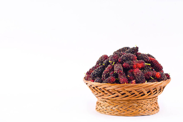  ripe mulberry in  brown basket is a fruit with vitamins. on white background healthy mulberry fruit food isolated - Photo, Image