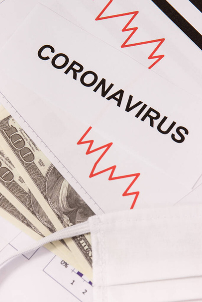 Currencies dollar with downward graphs representing financial crisis caused by coronavirus. Covid-19. Sars-CoV-2. 2019-nCoV - Φωτογραφία, εικόνα