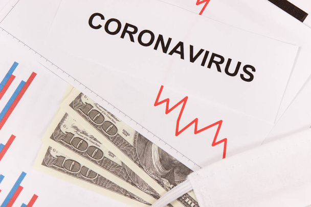 Currencies dollar with downward graphs representing financial crisis caused by coronavirus. Covid-19. Sars-CoV-2. 2019-nCoV - Photo, Image