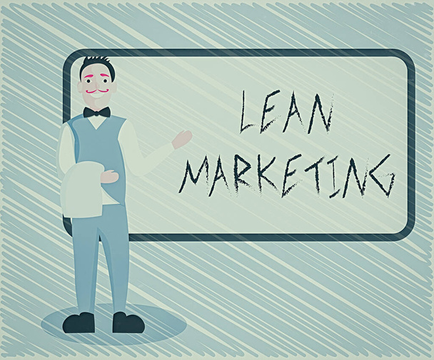 Text sign showing Lean Marketing. Conceptual photo in charge of testing retailing strategy and spot which works expertly Male Waiter Smiling Standing in Uniform Hand Presenting Blank Menu Board. - Photo, Image