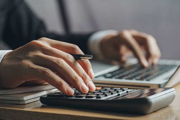 Close up businessman hand using calculator and laptop in office.finance concept - Fotoğraf, Görsel