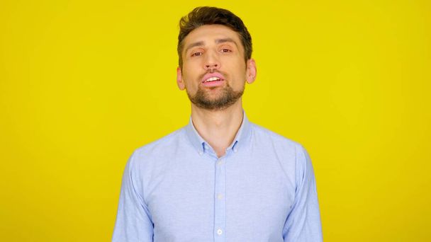Confident bearded man with open mouth on a yellow background with copyspace - Photo, Image