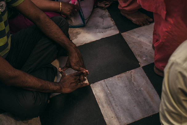 lidé sedí a modlí se nebo meditují na podlaze v Asii - Fotografie, Obrázek