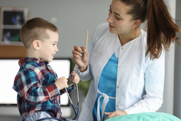 Child doctors appointment, plays with stethoscope - Photo, Image
