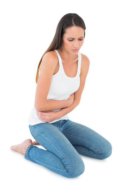 Displeased casual young woman with stomach pain - Photo, image