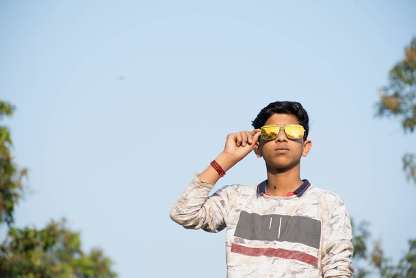 teenager boy portrait wearing sunglasses with isolated background - Photo, Image