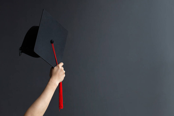 Raising hands with graduation cap on gray board.Celebration Education Graduation Student Success Learning Concept - Foto, Bild