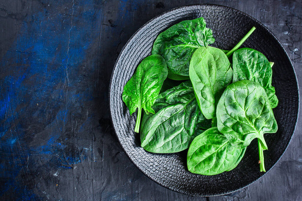 spinach green fresh leaves the petals snack vegetables bush green stems and petals Menu concept serving size. food background top view copy space for text keto or paleo diet organic healthy eating - Foto, Bild