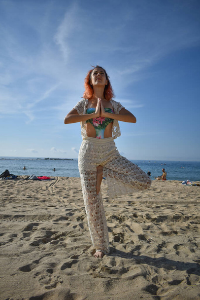 Женщина медитирует и делает йогу на пляже утром, песок и море
 - Фото, изображение