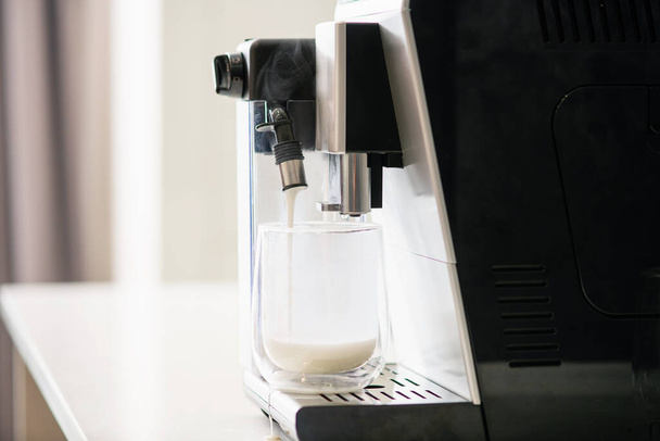 Milk flow from coffee machine to glass - Photo, Image