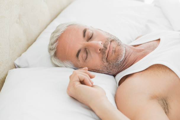 Mature man sleeping in bed at home - Photo, Image