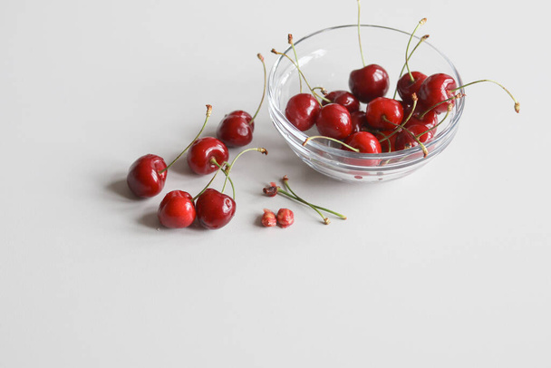 ripe juicy cherries on a white background macro photo - Foto, afbeelding