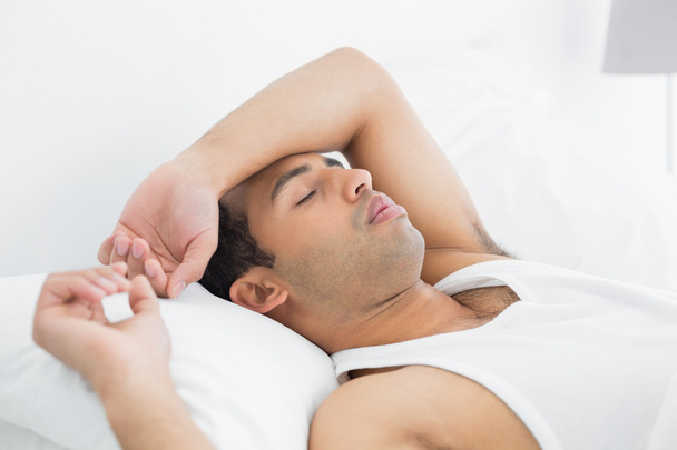 Young man sleeping in bed - Photo, Image