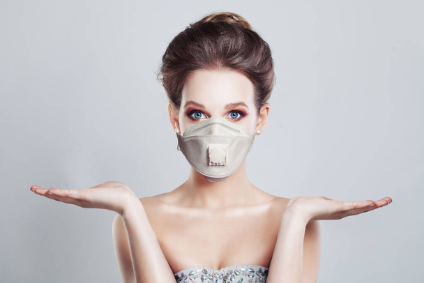 Pretty woman in protective mask showing her opening hands - Photo, Image