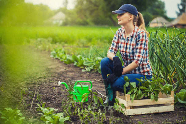 farmer girl at work in the garden. Organic farming - Fotó, kép