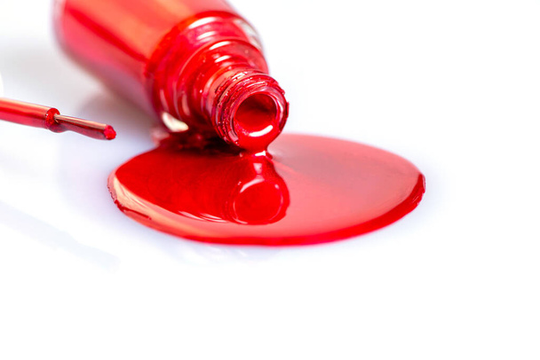 red nail polish spilled on a white table - Fotó, kép