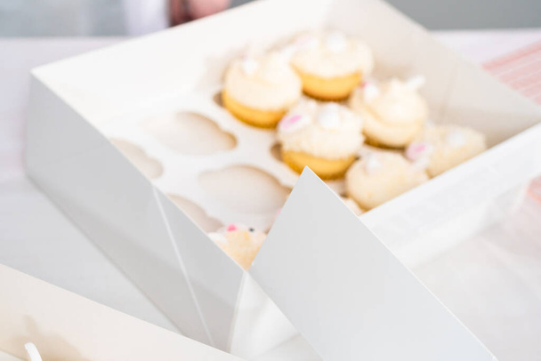 Easter bunny cupcakes in a white cupcake box. - Фото, зображення