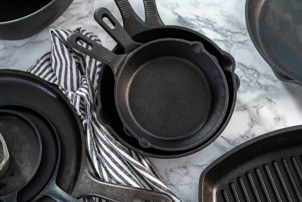 Variety of cast iron frying pans on a marble background. - Photo, Image