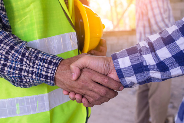 Construction worker team hands shaking greeting start up plan new project contract in office center at construction site, partnership and contractor concept - Foto, Bild
