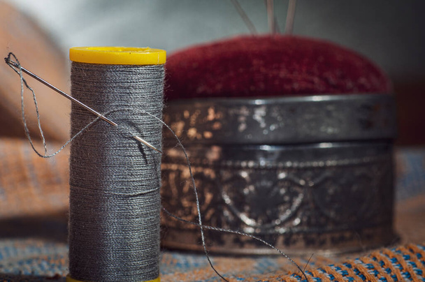 needle and thread sewing.grey thread ,with pin cushion - Fotoğraf, Görsel