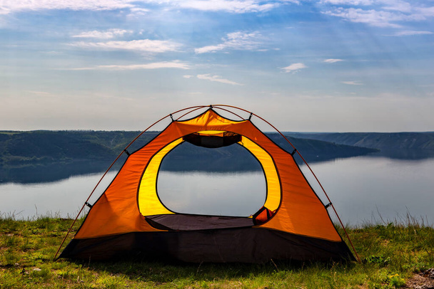 Tourist tent by the river overlooking the canyon. Outdoor recreation in summer. travel to Europe. - Photo, Image