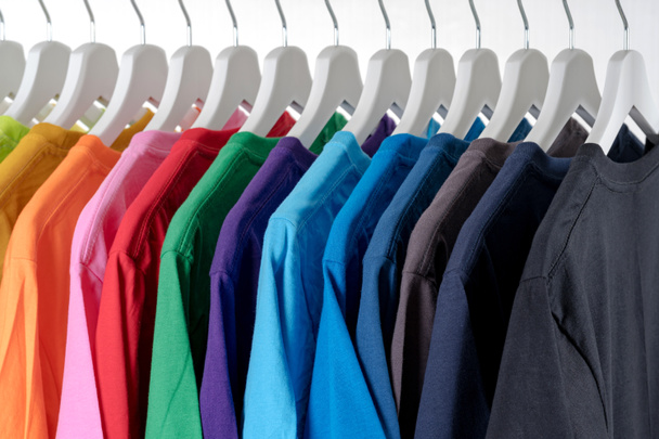 Close Up of t-shirts, Clothes on hangers on white background - Foto, immagini