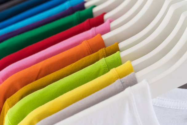 Close Up of t-shirts, Clothes on hangers on white background - Photo, Image