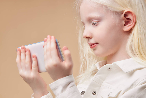portrait of attractive caucasian albino girl with smartphone - Фото, зображення