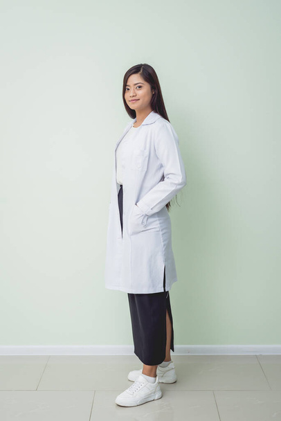 Asian woman ophtalmologist standing at hospital and looking at camera. - Φωτογραφία, εικόνα