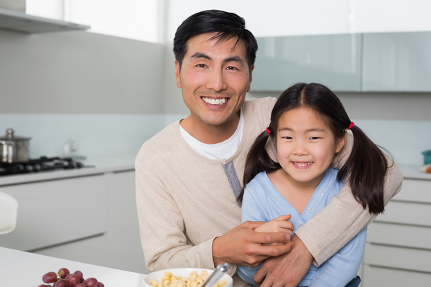 Portrait of a happy father with daughter in kitchen - Photo, image