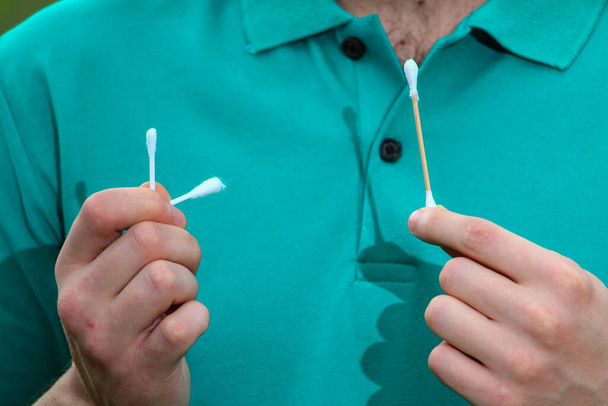 Plastic and wooden sticks with cotton wool. Broken plastic stick. Plastic rejection concept - Photo, Image