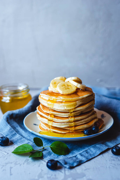 Stack of pancakes with fresh banana. - 写真・画像