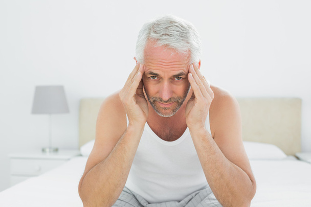 Mature man suffering from headache in bed - Photo, Image