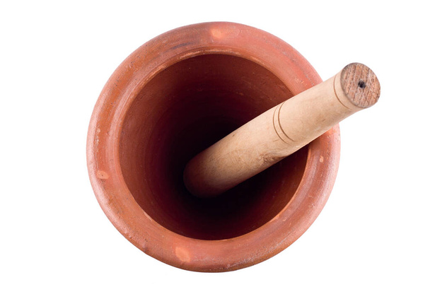 Top View of clay mortar and wood pestle on white background  cooking kitchenware object isolated - Photo, Image