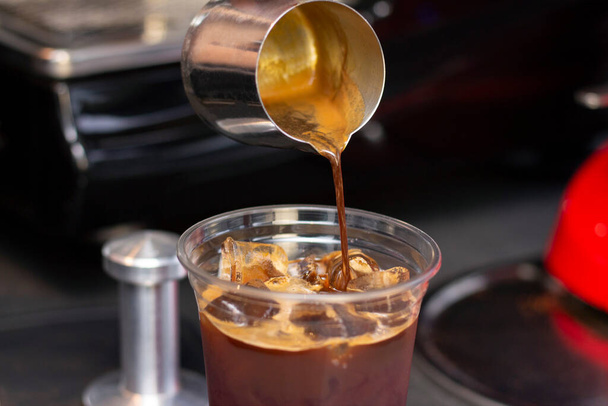 Ice coffee preparation preparation service concept. Barista. makes espresso in a coffee shop; close-up. Freshly ground coffee close up - Foto, immagini