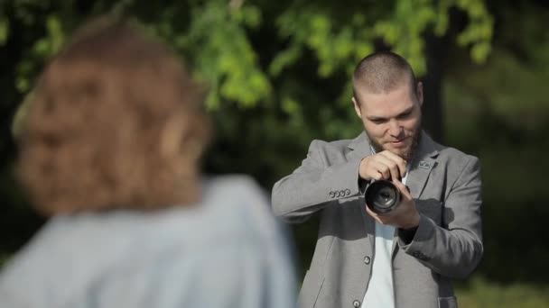 Photographer make photo session for model outdoor - Materiał filmowy, wideo